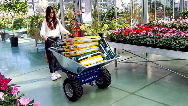 Carretilla de obra electrica D1 moviendo sacos de tierra en un vivero